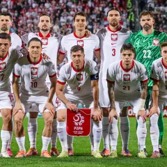 Reprezentacja Polski w piłce nożnej mężczyzn przed meczem z Maltą. Drużyna w białych strojach, z orłem na piersi, gotowa do gry.