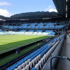 Puste trybuny stadionu Celta Vigo czekają na kibiców. Zielona murawa lśni w słońcu.