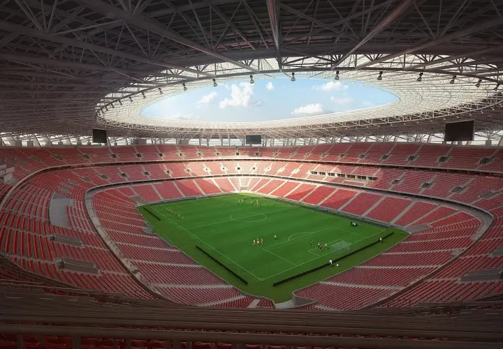 Nowy stadion w Budapeszcie z zieloną murawą i czerwonymi trybunami. Piłkarze trenują przed meczem.