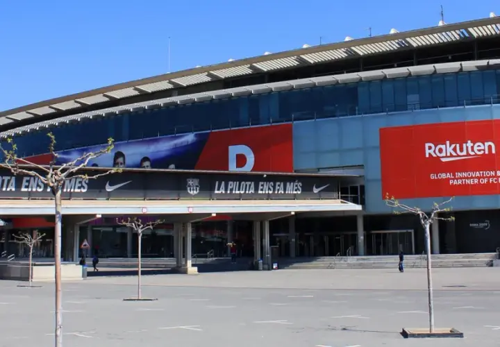 Stadion, gdzie gra Barcelona, z banerem Rakuten i herbem FCB.