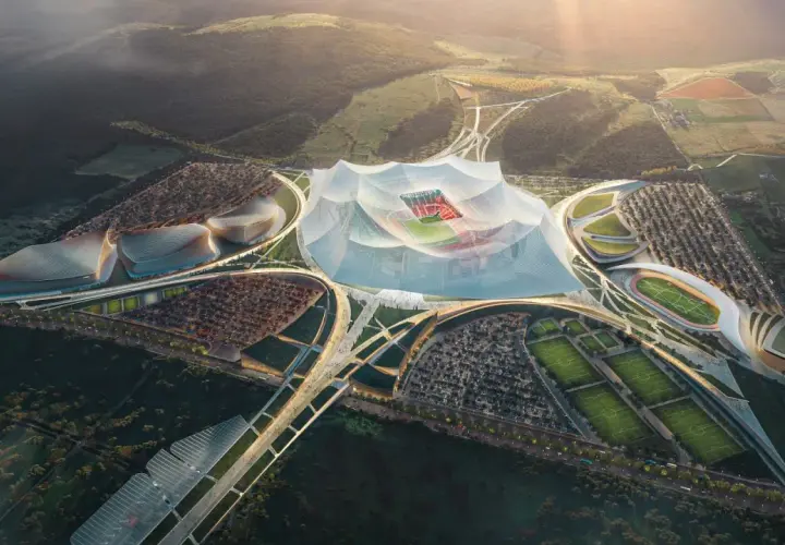 Futurystyczny kompleks sportowy z centralnym, zadaszonym stadionem, otoczony boiskami treningowymi i parkingami. Wygląda jak najwyżej położony stadion na świecie.