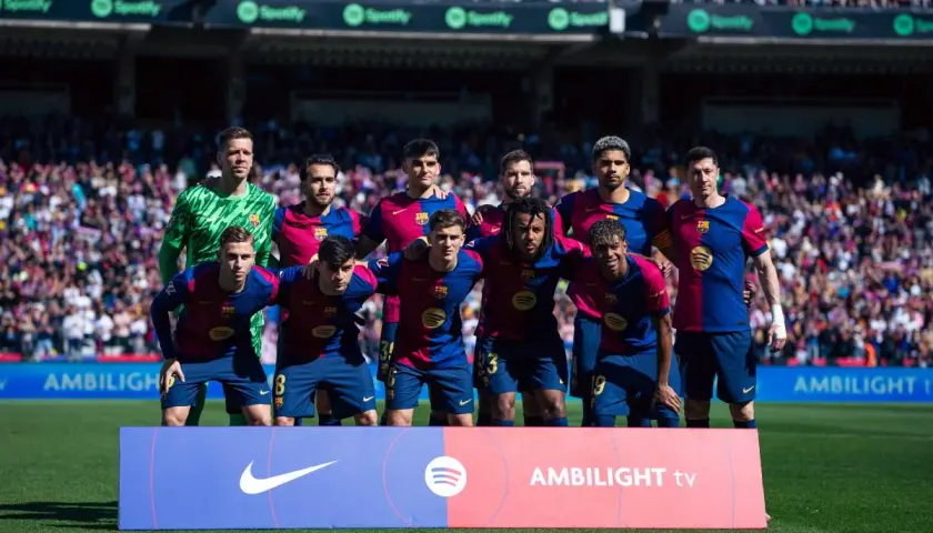 FC Barcelona B – zawodnicy w bordowo-granatowych strojach pozują do zdjęcia na murawie stadionu.