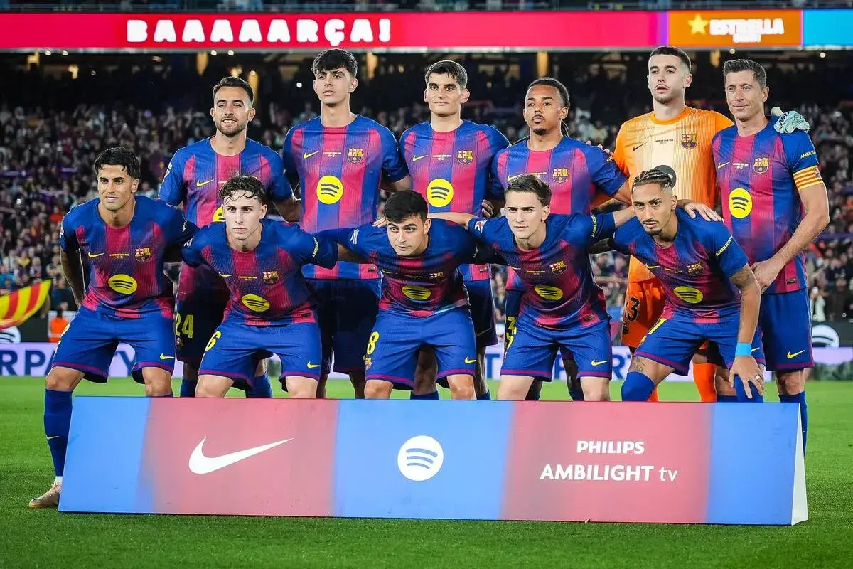 Drużyna FC Barcelona, w tym zawodnicy jak Lewandowski, Pedri i Gavi, pozuje do zdjęcia przed meczem.
