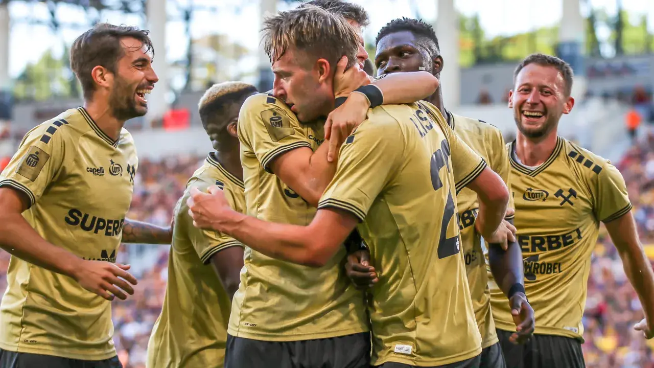 Radość zawodników Girona FC po zdobytej bramce. Piłkarze w złotych koszulkach świętują razem.