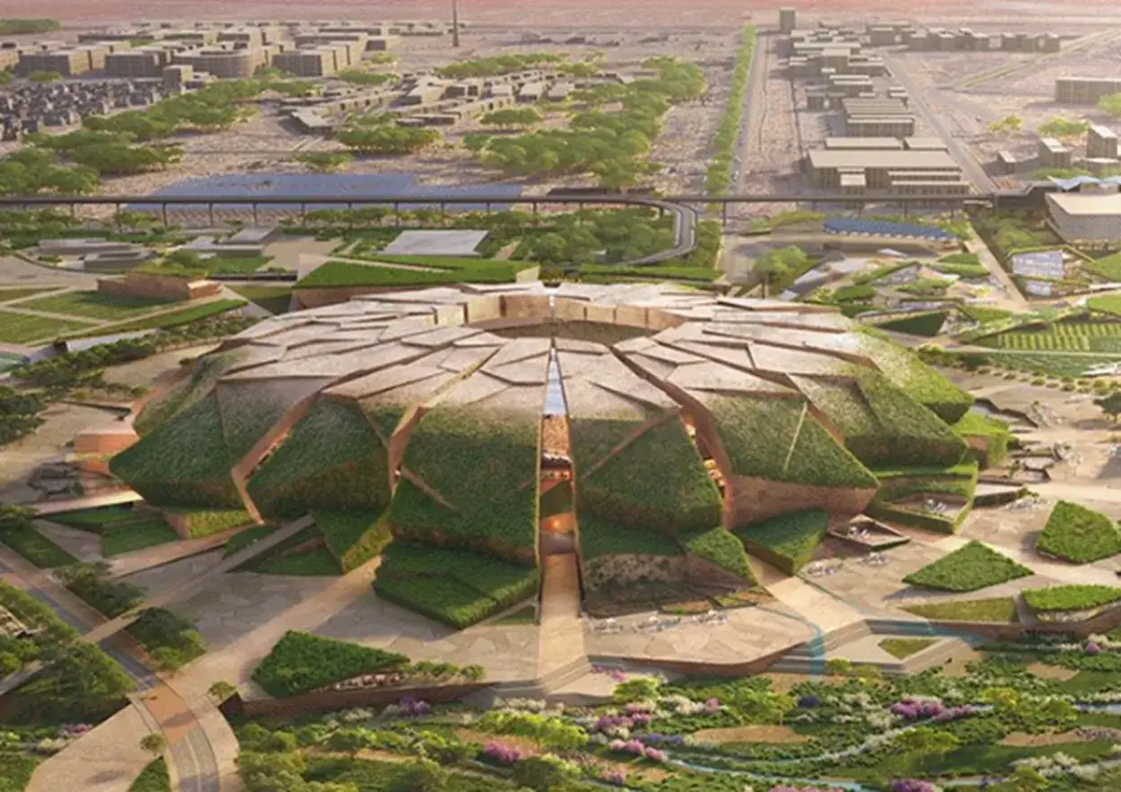 Futurystyczny stadion, gdzie będzie mundial 2034. Obiekt pokryty zielenią, otoczony nowoczesną zabudową i parkami.