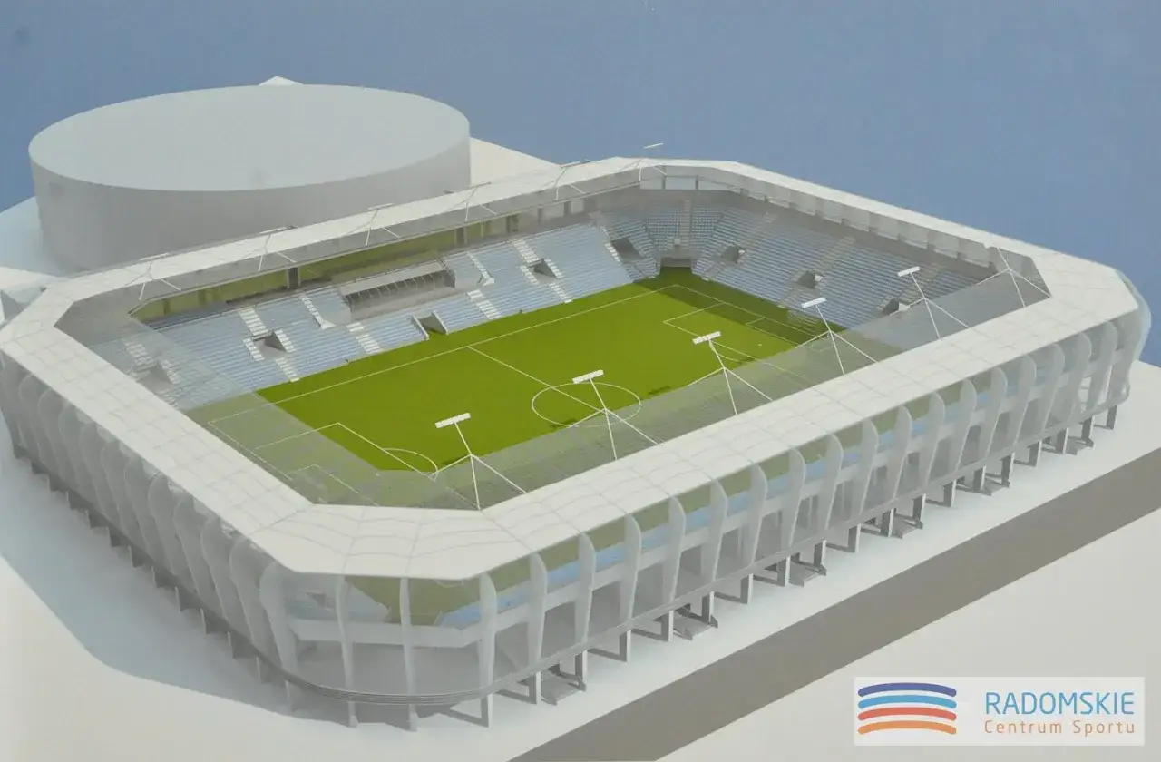 Model nowoczesnego stadionu im. Braci Czachorów z zieloną murawą i błękitnymi trybunami.