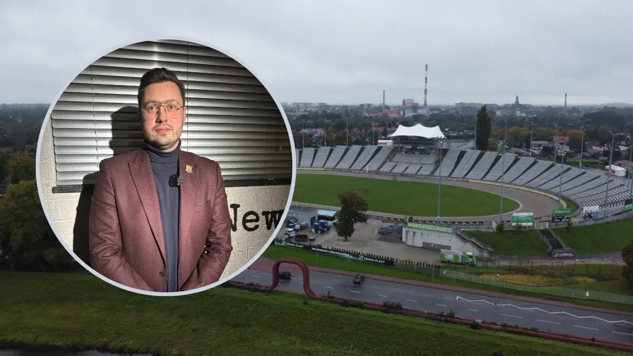 Mężczyzna w garniturze na tle stadionu Włókniarz Częstochowa.
